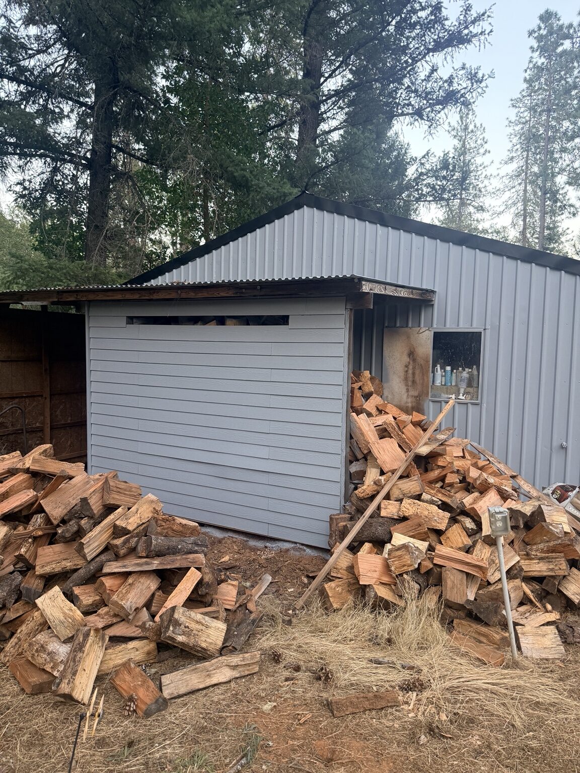 Front elevation of the repainted metal outbuilding